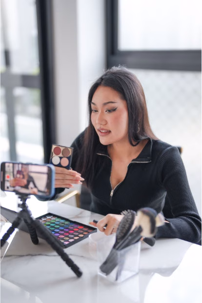 Professional social media marketing team creating strategy with analytics dashboard showing Facebook, Instagram, LinkedIn and TikTok engagement metrics and ROI growth
